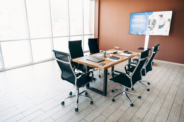 Professional office meeting room with modern furniture and presentation display set up for business discussions