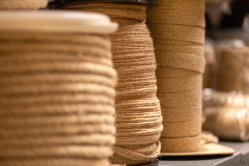 Spools of natural twine arranged on shelves in workshop