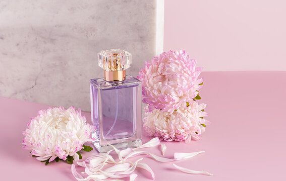 Perfume bottle with delicate pink aster flowers