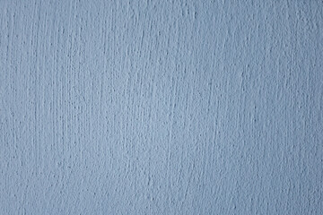Blue textured wall background. Minimal blue wall surface with fine texture and soft light, suitable for abstract backgrounds or design templates.