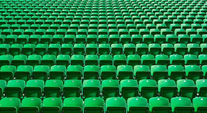 Rows of empty green stadium seats ready for a sporting event or concert