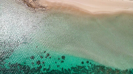 Aerial view of Coral Bay and beach in Western Australia with turquoise ocean and white sand