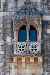 Detail of Belem tower on the river near lisboa, where vasco dagama left for the world. moon on the blue sky background.