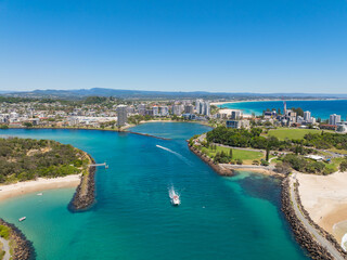 Fototapeta premium Aerial views of the Tweed Heads coast with Fingal Head to the south and Duranbah beach to the north, the Tweed river inlet in the foreground and Tweed Heads and Coolangatta skyline in the background