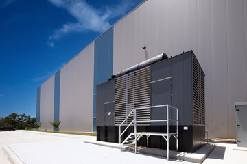 One large standby diesel generator outside warehouse	