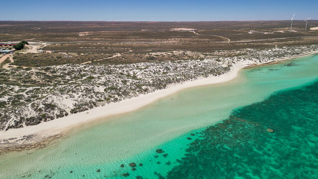 Aerial view of Coral Bay and beach in Western Australia with turquoise ocean and white sand
