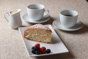 Bizcocho slice serving with coffee and berries
