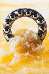 Ball bearing immersed in grease, close-up view