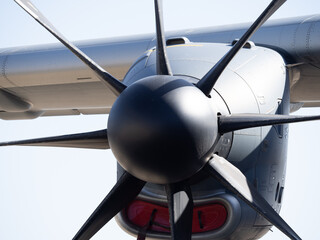 Close-up view of large multi-blade propeller and engine nacelle attached under aircraft wing