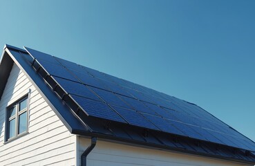 Modern house roof features dark blue solar panels. Panels gather sun energy, producing clean power. Home uses renewable tech for electricity generation. Domestic building reduces carbon footprint,