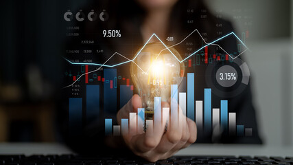 A business professional displays a light bulb symbolizing innovation amidst dynamic graphs and charts, representing growth strategies and market analysis in finance. Scalp