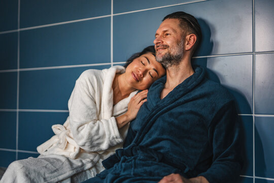 Relaxing couple enjoying spa day together in bathrobes - Powered by Adobe