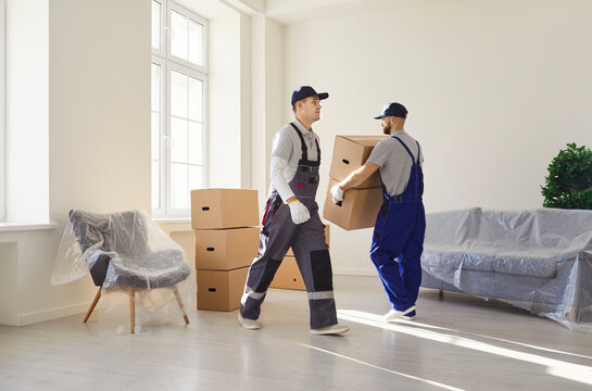 Mover team staff manages relocation to new home or office, moving box with deliver service in a professional setting with focus on efficiency and teamwork in a dedicated environment.