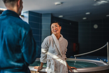 Couple enjoying spa wellness and relaxation at resort hot tub