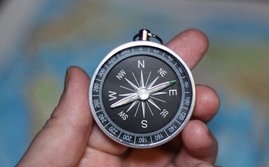 compass in hand and the map atlas 