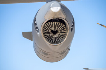 Rearward view of a turboprop engine nacelle showing radial fabric shielding across the exhaust section of the propulsion system