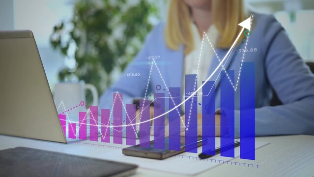 Businesswoman Analyzes Business Statistics as Holographic Charts And Graphs