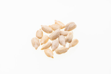 Helianthus annuus - Pile of hulled sunflower seeds on a white background