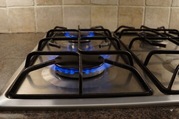 Gas Stove with Two Blue Flames in Kitchen 