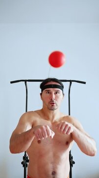 athletic juggling drill, individual engaging in quick reaction training with energetic movements, athlete without shirt practicing timing and focus through dynamic juggling and punching. fight ball