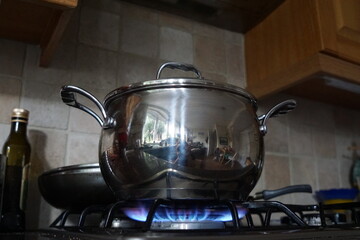 Shiny Metal Pot Boiling on Gas Stove in Home Kitchen