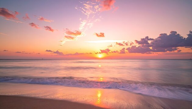 Serene ocean sunset with vibrant orange and pink clouds reflecting on calm water and wet sand shore during golden hour