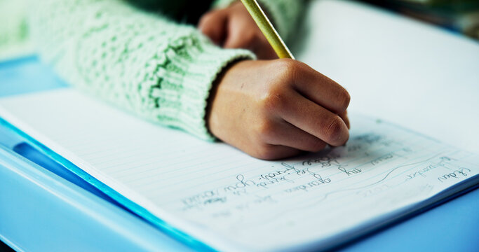 Learning, hands and child writing in classroom for fine motor skills, language activity or assessment. Book, kid student and handwriting practice at school for academic development, literacy or study
