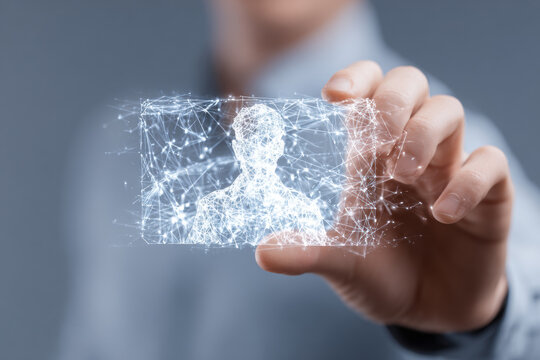 A hand pinching a holographic card frame with a glowing blue wireframe human profile, symbolizing future identity authentication, data security, and biometric technology. - Powered by Adobe