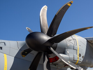 Side view of the turboprop engine nacelle with its multi-blade propeller assembly and aerodynamic contours under clear blue sky