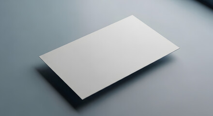 Single blank white business card floating on a sleek grey background with soft shadows, professional mockup.