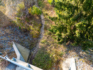 A small dried up creek and bridge during fall. 