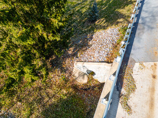 A small dried up creek and bridge during fall. 