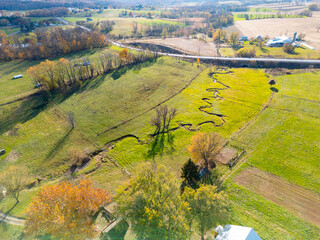 A farm and farmhouse during sunset. Aerial drone. 