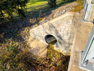 A small dried up creek and bridge during fall. 