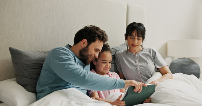 Parents, girl and tablet in bed, happy and bonding with online games, care or connection in home. People, mother and daughter with dad, tech and relax with application for puzzle at family house