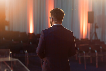 Business speaker giving presentation on stage at conference