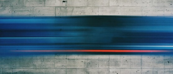 A blurred motion of a passing train against a concrete wall.