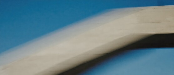 Abstract architecture featuring a blurred concrete structure against a vivid blue background.