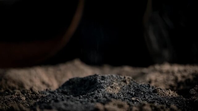 Medium shot of hands mixing rich compost into garden soil highlighting natural organic matter improving microbial activity and soil fertility.