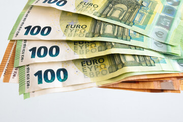 Stack of 100 euro banknotes macro close-up showing European currency and finance background, concept of money, investment, savings, and business economy