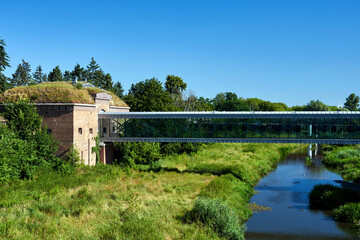 Historic Prussian fortress and modern footbridge over the Warta River in Poznan