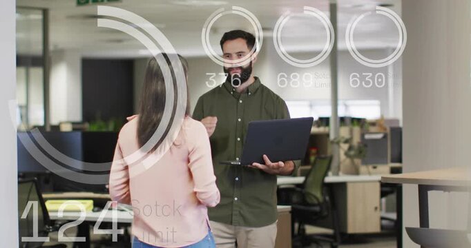 Bearded man pointing at laptop, woman leaning, business HUD charts updating, checking stock limits