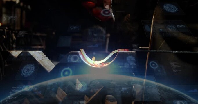 Hammer dropping, worker striking hot U shape metal, shaping inner curve as blue overlay appears