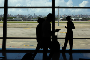 Passengers Waiting for Delayed Flight While Looking at Phone