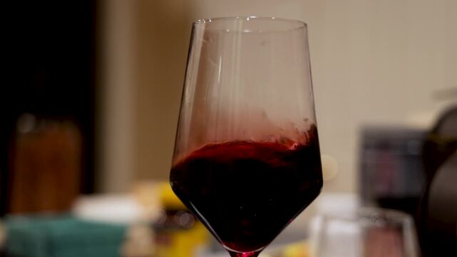 Red Wine Swirled Slowly In Elegant Glass
