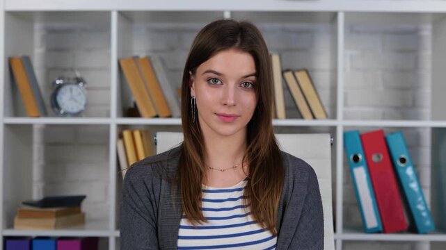 Woman posing to webcam and making video at home, online, videocall meeting