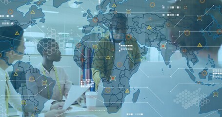 Man presenting approaching table leaning and gesturing activating laptop HUD aligning design team - Powered by Adobe