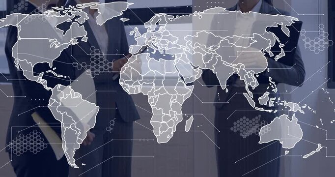 Three businesswomen tapping tablet and gesturing as animated world map gaining detail for briefing