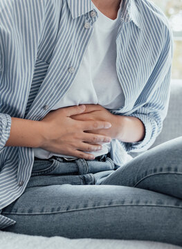 Sick young woman in pain holding belly stomach feeling hurt abdomen ache gastritis pancreatitis symptoms or diarrhea, upset teen girl suffering from indigestion flatulence abdominal problem concept