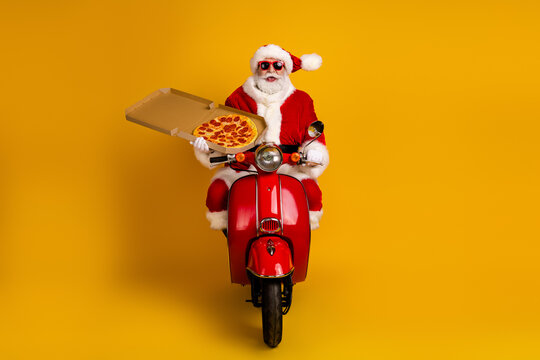 Santa on a red scooter delivers a pizza in bright yellow studio celebrating Christmas family fun with a festive vibe playful holiday mood